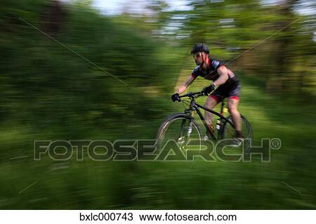 Man riding mountain bike in nature in the Bologna countryside, Italy View Large Photo Image Stock Image - Man riding mountain bike in nature in the Bologna countryside, Italy. Fotosearch