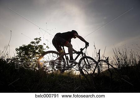 Man riding mountain bike in nature in the Bologna countryside, Italy View Large Photo Image Stock Image - Man riding mountain bike in nature in the Bologna countryside, Italy. Fotosearch