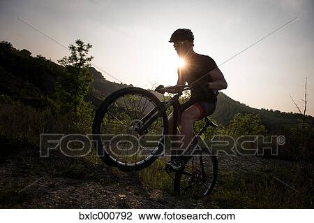 Man riding mountain bike in nature in the Bologna countryside, Italy View Large Photo Image Stock Image - Man riding mountain bike in nature in the Bologna countryside, Italy. Fotosearch