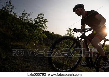 Man riding mountain bike in nature in the Bologna countryside, Italy View Large Photo Image Stock Image - Man riding mountain bike in nature in the Bologna countryside, Italy. Fotosearch