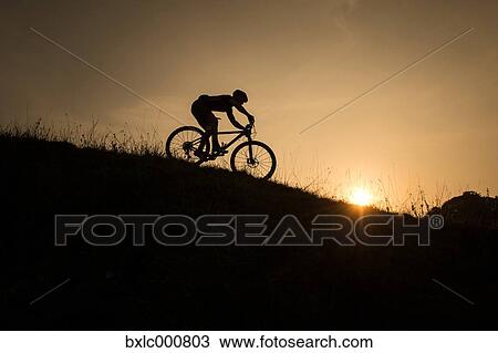 Stock Image - Man riding mountain bike in nature in the Bologna countryside, Italy. Fotosearch