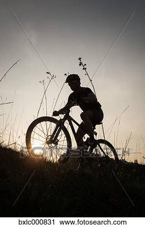 Stock Image - Man riding mountain bike in nature in the Bologna countryside, Italy. Fotosearch