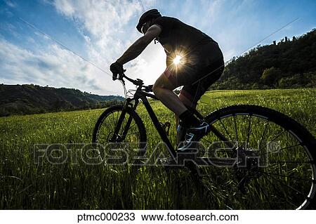 Stock Image - Man riding mountain bike in nature in the Bologna countryside, Italy. Fotosearch