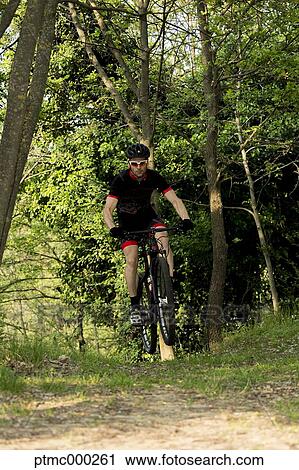 Stock Image - Man riding mountain bike in nature in the Bologna countryside, Italy. Fotosearch