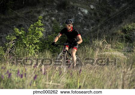 Man riding mountain bike in nature in the Bologna countryside, Italy View Large Photo Image Stock Image - Man riding mountain bike in nature in the Bologna countryside, Italy. Fotosearch