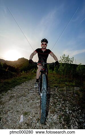 Stock Image - Man riding mountain bike in nature in the Bologna countryside, Italy. Fotosearch