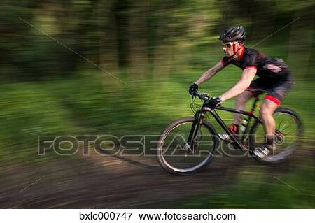 Man riding mountain bike in nature in the Bologna countryside, Italy View Large Photo Image Stock Photo - Man riding mountain bike in nature in the Bologna countryside, Italy. Fotosearch