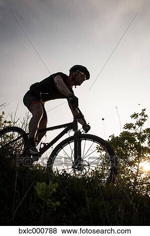 Man riding mountain bike in nature in the Bologna countryside, Italy View Large Photo Image Stock Photo - Man riding mountain bike in nature in the Bologna countryside, Italy. Fotosearch