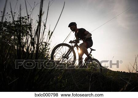 Man riding mountain bike in nature in the Bologna countryside, Italy View Large Photo Image Stock Photo - Man riding mountain bike in nature in the Bologna countryside, Italy. Fotosearch