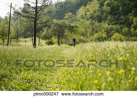 Stock Photo - Man riding mountain bike in nature in the Bologna countryside, Italy. Fotosearch