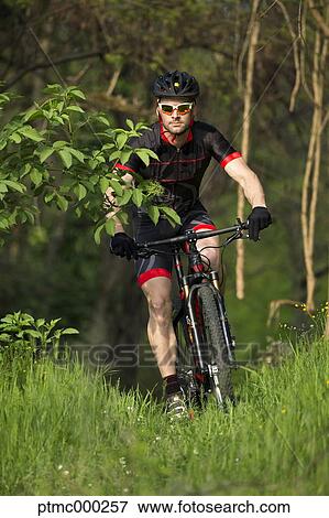 Stock Photo - Man riding mountain bike in nature in the Bologna countryside, Italy. Fotosearch