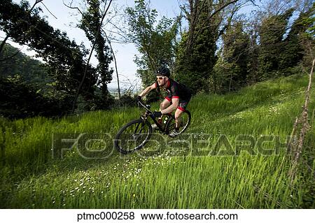 Stock Photo - Man riding mountain bike in nature in the Bologna countryside, Italy. Fotosearch