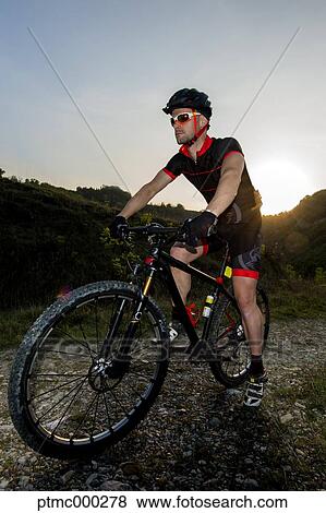 Man riding mountain bike in nature in the Bologna countryside, Italy View Large Photo Image Stock Photo - Man riding mountain bike in nature in the Bologna countryside, Italy. Fotosearch