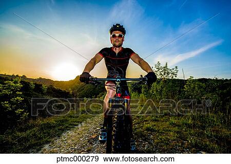 Man riding mountain bike in nature in the Bologna countryside, Italy View Large Photo Image Stock Photo - Man riding mountain bike in nature in the Bologna countryside, Italy. Fotosearch