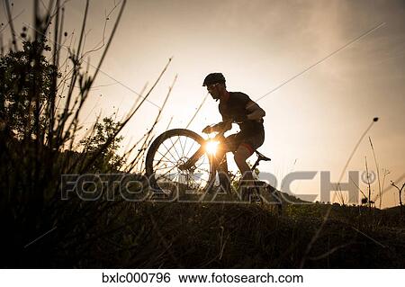 Man riding mountain bike in nature in the Bologna countryside, Italy View Large Photo Image Stock Photograph - Man riding mountain bike in nature in the Bologna countryside, Italy. Fotosearch