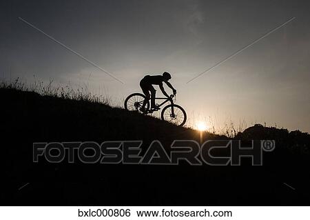 Man riding mountain bike in nature in the Bologna countryside, Italy View Large Photo Image Stock Photograph - Man riding mountain bike in nature in the Bologna countryside, Italy. Fotosearch