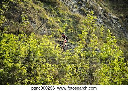 Man riding mountain bike in nature in the Bologna countryside, Italy View Large Photo Image Stock Photograph - Man riding mountain bike in nature in the Bologna countryside, Italy. Fotosearch