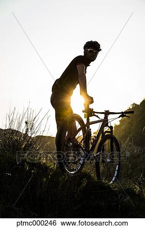 Man riding mountain bike in nature in the Bologna countryside, Italy View Large Photo Image Stock Photograph - Man riding mountain bike in nature in the Bologna countryside, Italy. Fotosearch