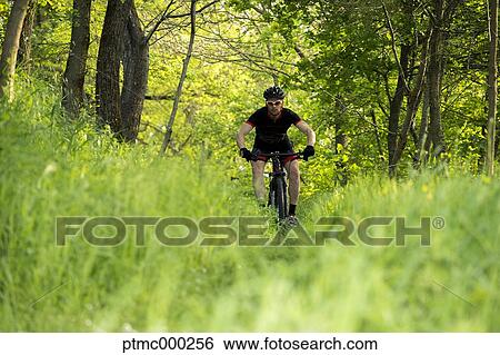 Man riding mountain bike in nature in the Bologna countryside, Italy View Large Photo Image Stock Photograph - Man riding mountain bike in nature in the Bologna countryside, Italy. Fotosearch