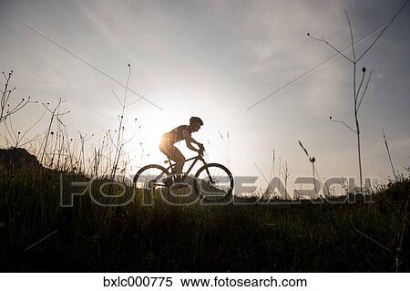 Stock Photography - Man riding mountain bike in nature in the Bologna countryside, Italy. Fotosearch