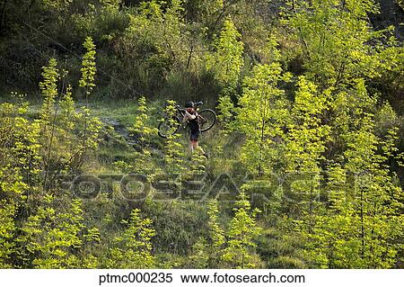Stock Photography - Man riding mountain bike in nature in the Bologna countryside, Italy. Fotosearch