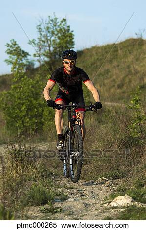 Man riding mountain bike in nature in the Bologna countryside, Italy View Large Photo Image Stock Photography - Man riding mountain bike in nature in the Bologna countryside, Italy. Fotosearch