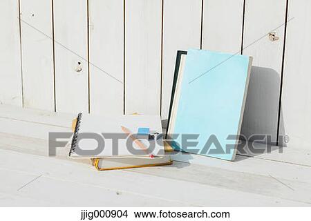 Pencil and notebooks against white wooden wall View Large Photo Image Picture - Pencil and notebooks against white wooden wall. Fotosearch