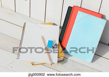 Pencil and notebooks against white wooden wall View Large Photo Image Stock Image - Pencil and notebooks against white wooden wall. Fotosearch