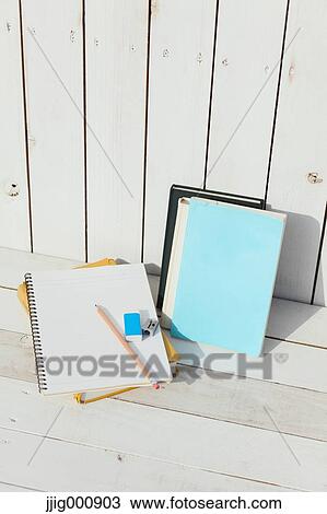 Pencil and notebooks against white wooden wall View Large Photo Image Stock Image - Pencil and notebooks against white wooden wall. Fotosearch
