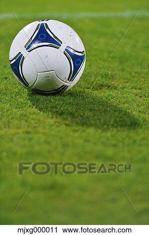 Stock Image - Soccer ball on grassland. Fotosearch