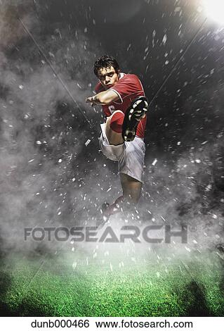 Soccer Player Kicking In Mid-Air View Large Photo Image Stock Photograph - Soccer Player Kicking In Mid-Air. Fotosearch