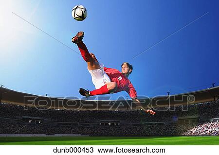Soccer Player Kicking The Ball In Mid-Air View Large Photo Image Stock Image - Soccer Player Kicking The Ball In Mid-Air. Fotosearch