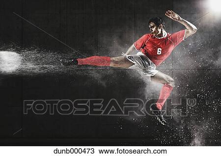 Soccer Player Kicking The Ball In Mid-Air View Large Photo Image Stock Image - Soccer Player Kicking The Ball In Mid-Air. Fotosearch