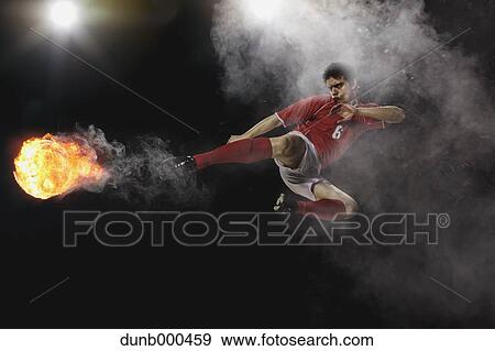 Soccer Player Kicking The Ball In Mid-Air View Large Photo Image Stock Photo - Soccer Player Kicking The Ball In Mid-Air. Fotosearch