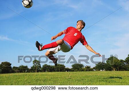 Soccer Player Kicking The Ball In Mid-Air View Large Photo Image Stock Photo - Soccer Player Kicking The Ball In Mid-Air. Fotosearch