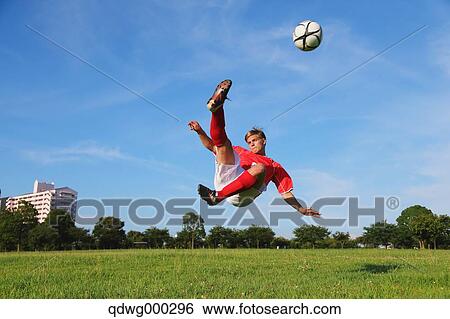 Soccer Player Kicking The Ball In Mid-Air View Large Photo Image Stock Photograph - Soccer Player Kicking The Ball In Mid-Air. Fotosearch