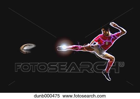 Soccer Player Kicking The Ball In Mid-Air View Large Photo Image Stock Photography - Soccer Player Kicking The Ball In Mid-Air. Fotosearch