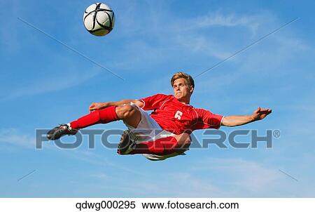 Soccer Player Kicking The Ball In Mid-Air View Large Photo Image Stock Photography - Soccer Player Kicking The Ball In Mid-Air. Fotosearch