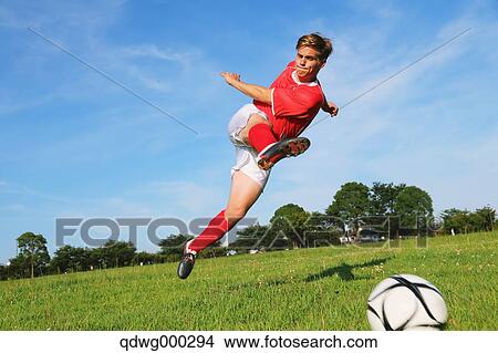 Picture - Soccer Player Kicking The Ball. Fotosearch