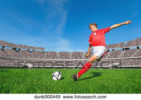Soccer Player Kicking The Ball View Large Photo Image Stock Photo - Soccer Player Kicking The Ball. Fotosearch