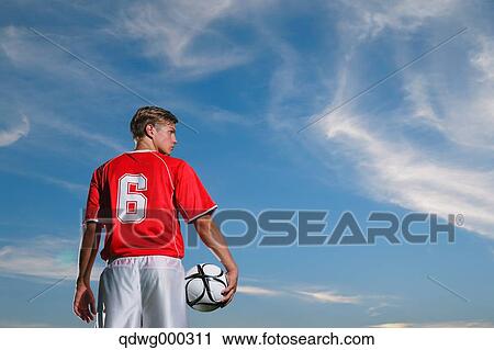 Stock Image - Soccer Player Standing With Ball. Fotosearch