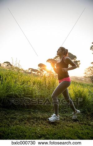 Young Girl Running In A Park View Large Photo Image Stock Image - Young Girl Running In A Park. Fotosearch