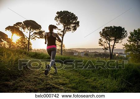 Young Girl Running In A Park View Large Photo Image Stock Image - Young Girl Running In A Park. Fotosearch