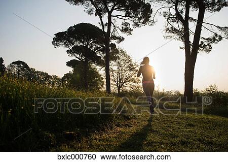 Stock Image - Young Girl Running In A Park. Fotosearch