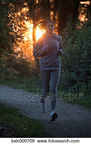 Stock Photo - Young Girl Running In A Park. Fotosearch