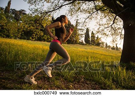 Young Girl Running In A Park View Large Photo Image Stock Photo - Young Girl Running In A Park. Fotosearch