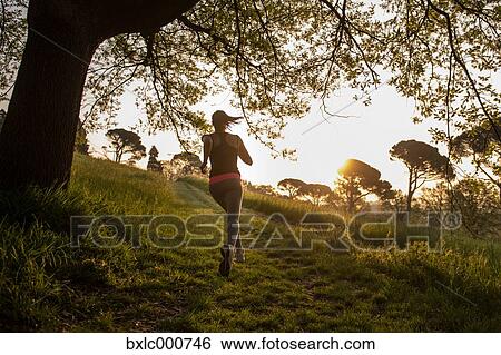 Young Girl Running In A Park View Large Photo Image Stock Photograph - Young Girl Running In A Park. Fotosearch