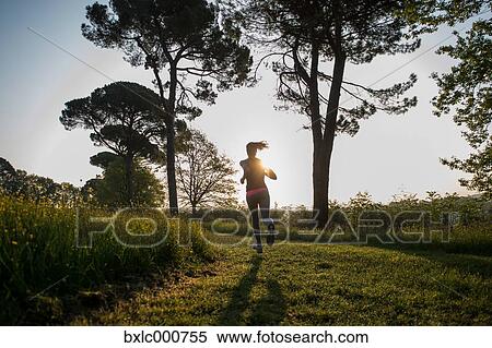 Young Girl Running In A Park View Large Photo Image Stock Photography - Young Girl Running In A Park. Fotosearch