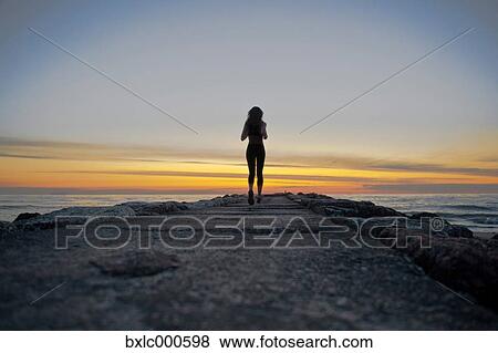 Stock Photo - Young Girl Running On A Pier. Fotosearch