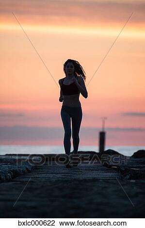 Young Girl Running On The Beach View Large Photo Image Stock Image - Young Girl Running On The Beach. Fotosearch